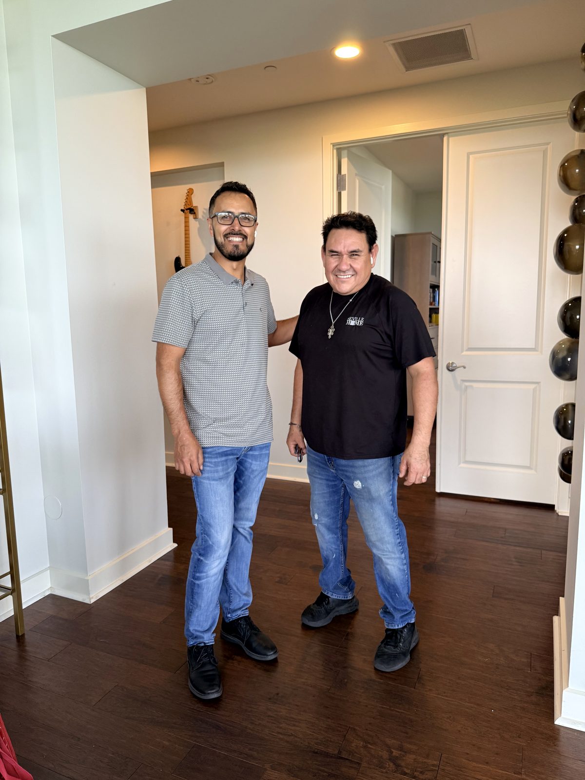 Two Trade Receiving crew members in a client's home on install day